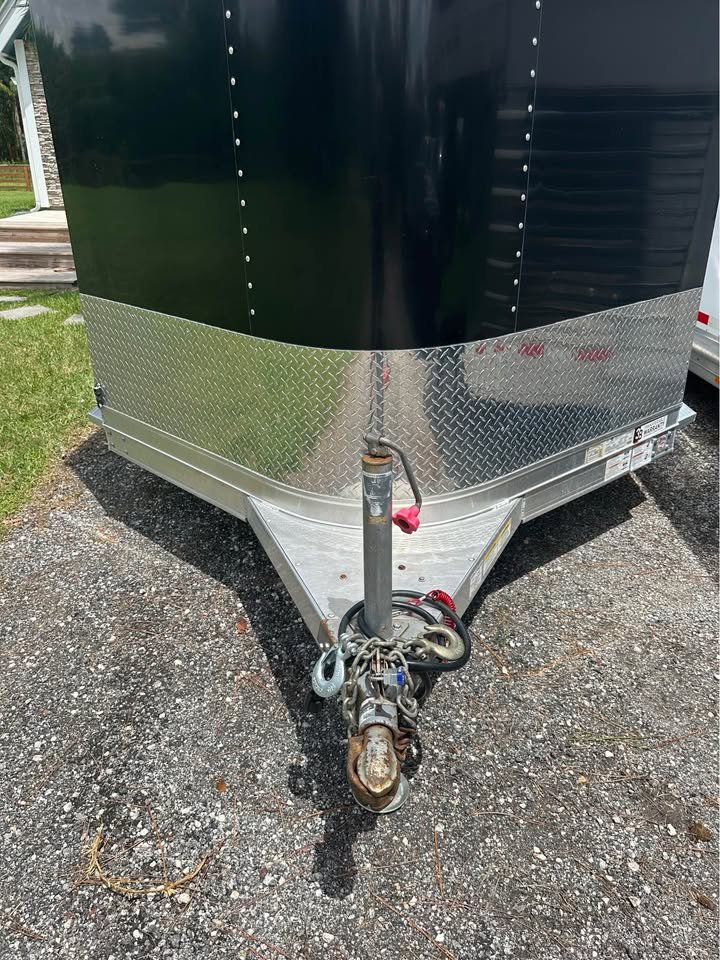 Detail of the tandem rubber torsion axles and electric brakes on a late-model Exiss trailer