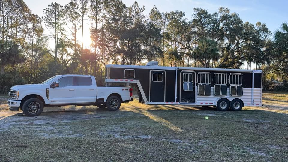 Side profile of a 2008 Featherlite 4-horse gooseneck trailer featuring the Weekender living package