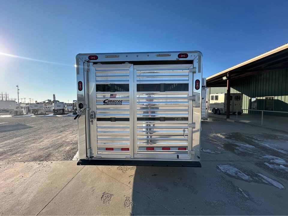 Rear view of the 2026 Cimarron stock trailer with a full swing gate and slider."