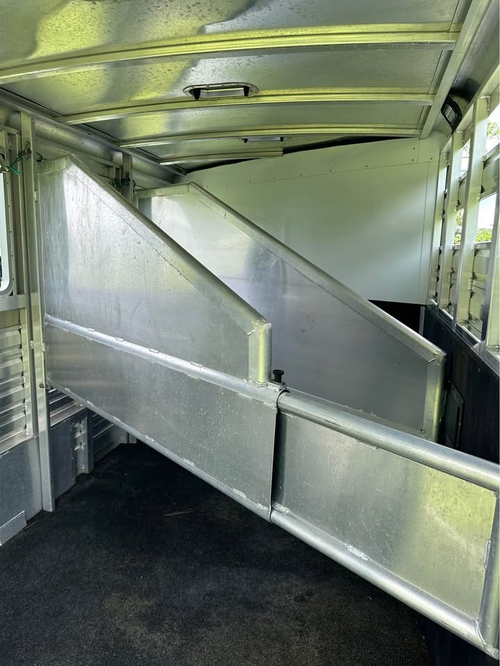 Interior of the 3-horse area featuring padded aluminum slant dividers and rubber floor mats.