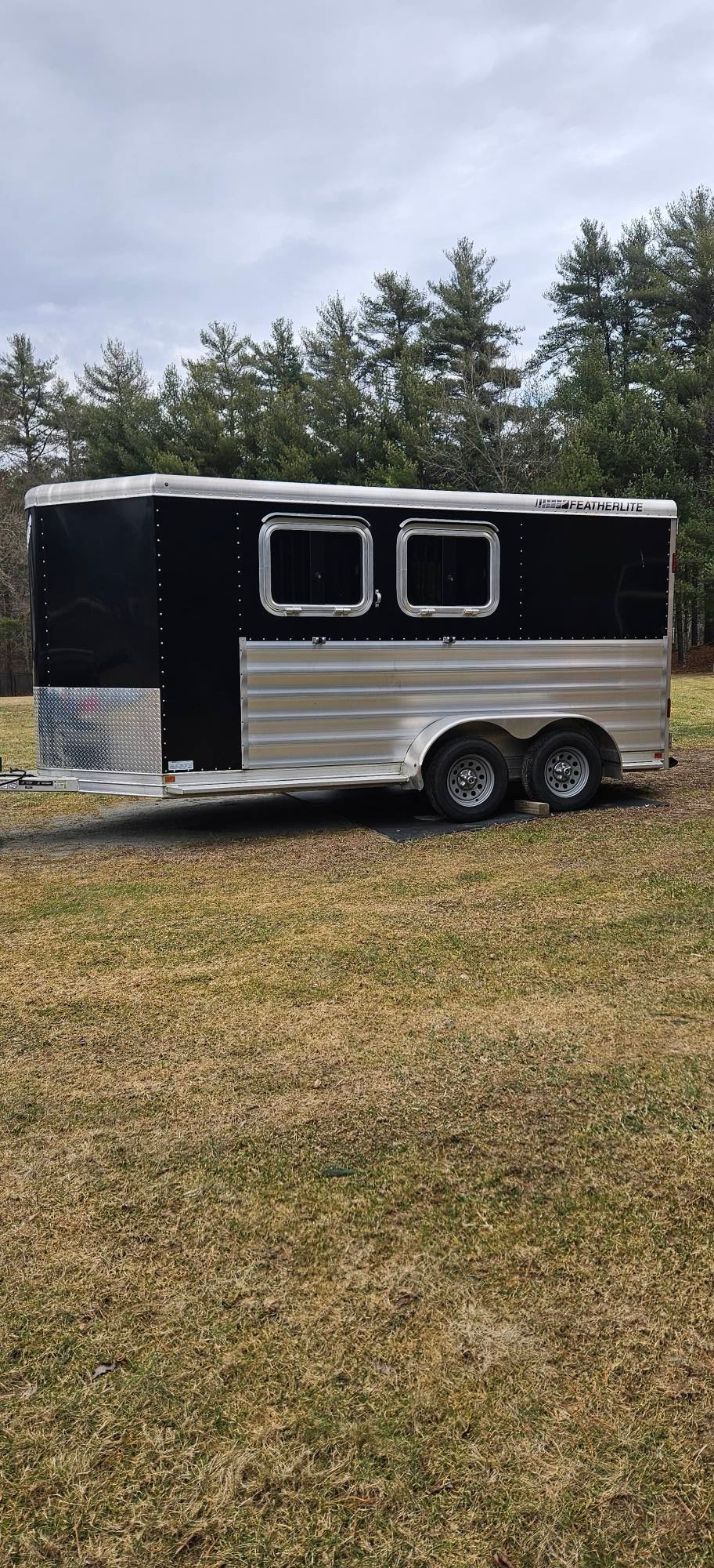 Side view of the lightweight all-aluminum Featherlite trailer designed for easy towing with smaller trucks