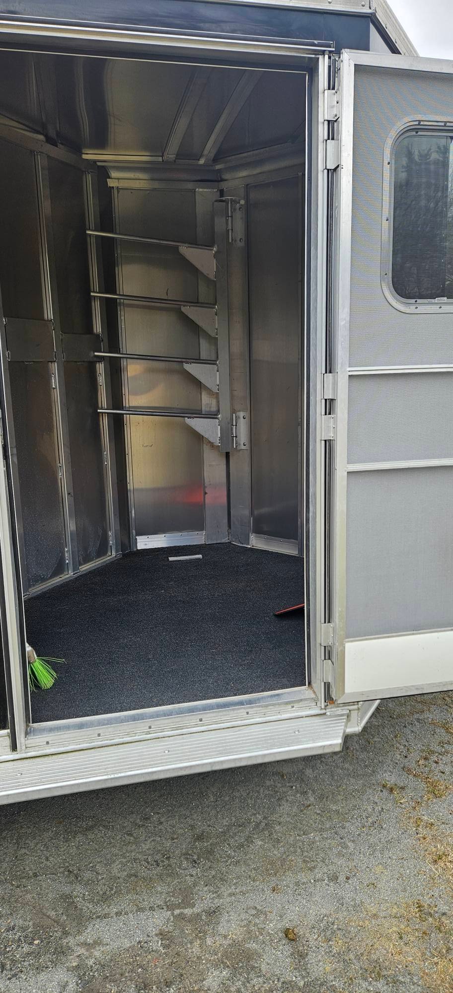 The front dressing room features turf flooring, a brush tray, and a secure camper door