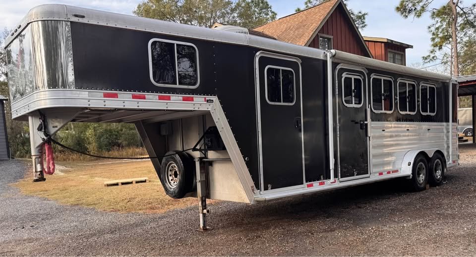 Heavy-duty tandem rubber torsion axles and aluminum wheels on a pre-owned 2008 Featherlite