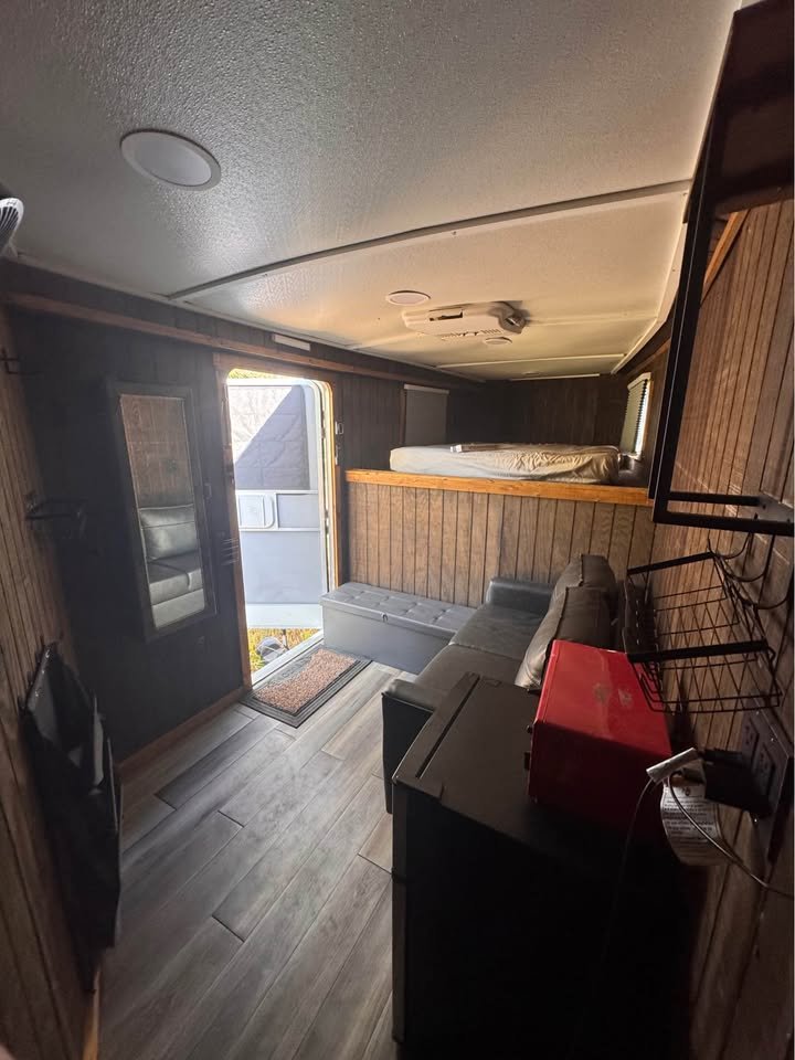 A lined and insulated interior cabin with overhead storage and electrical outlets for convenience