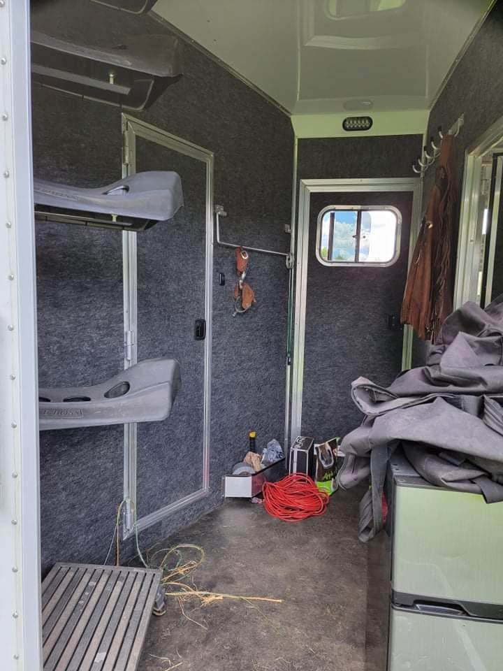 Padded slant stall dividers with spring-loaded latches for maximum horse safety and comfort