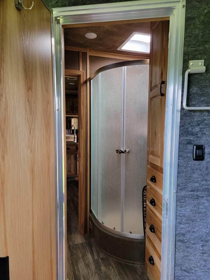 The private bathroom in a Lakota Bighorn featuring a radius shower and porcelain toilet