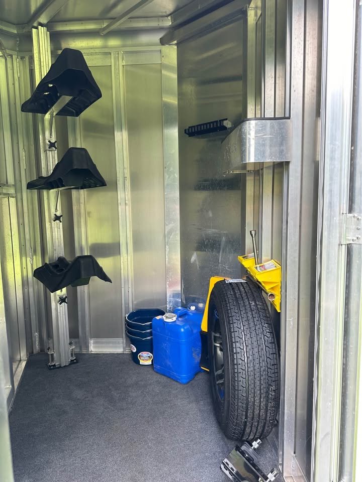 The front dressing room includes a blanket bar, brush tray, and ample storage for equestrian gear